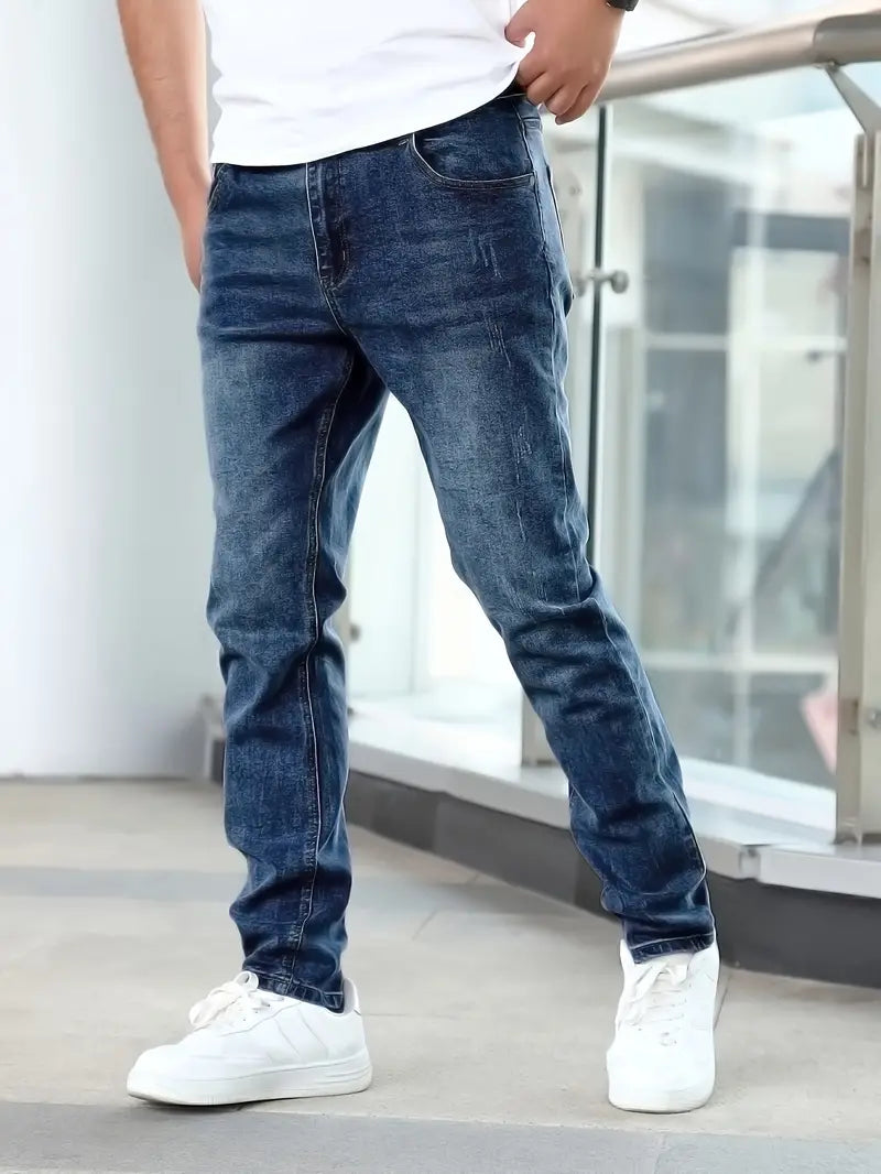 Person wearing blue jeans and white sneakers in an indoor setting