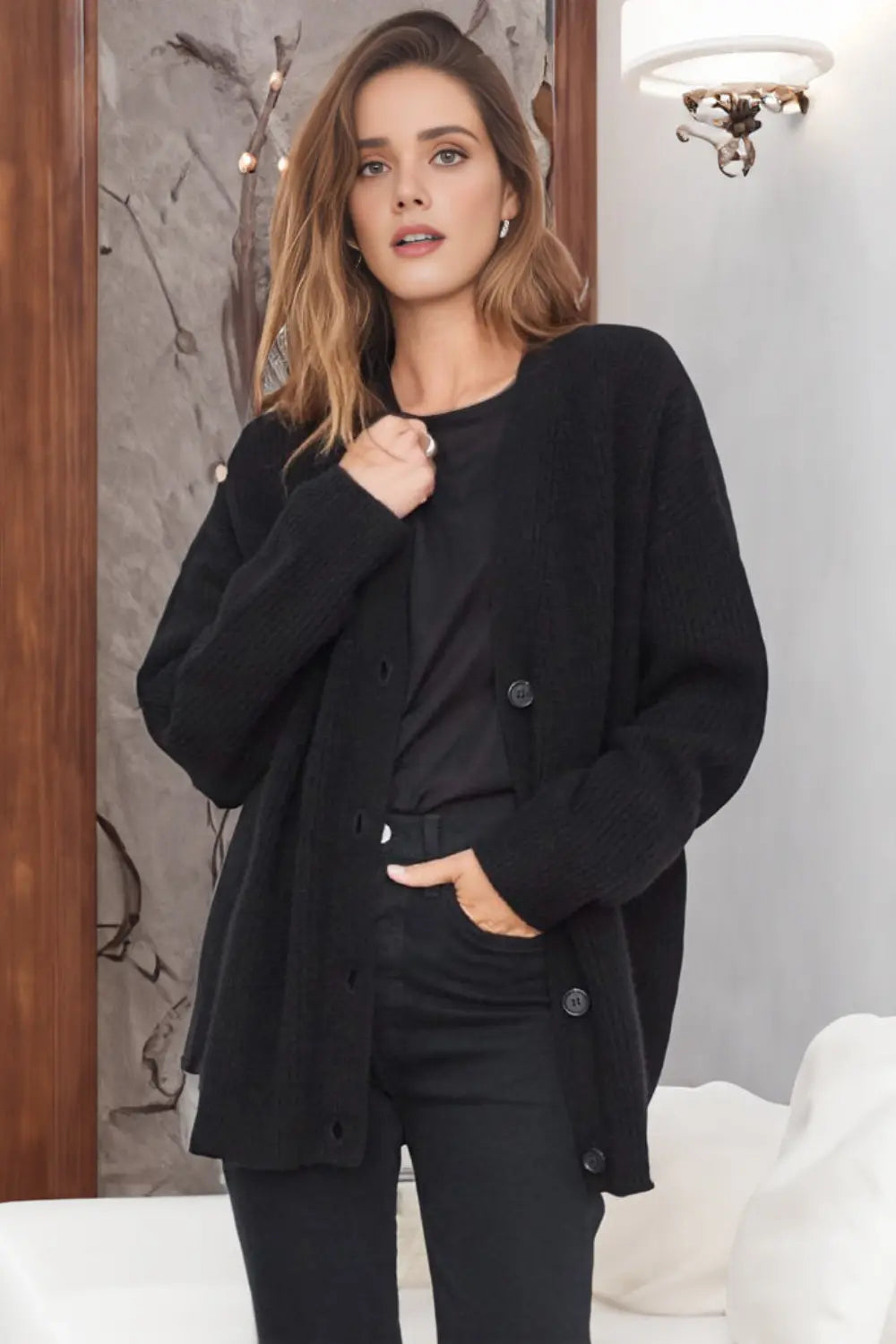 Woman wearing a black coat in an indoor setting