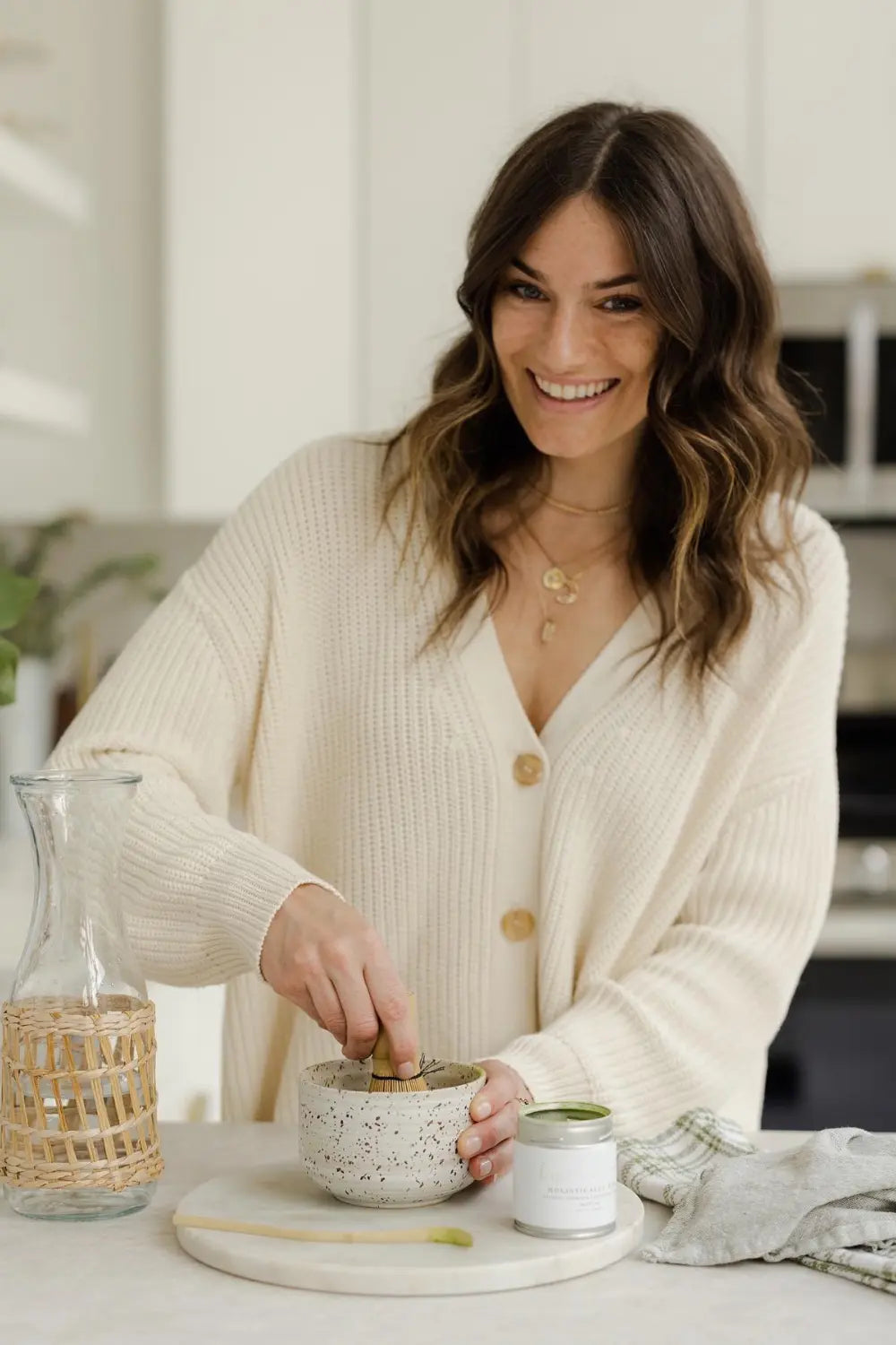 Woman in a kitchen preparing food on a white countertop