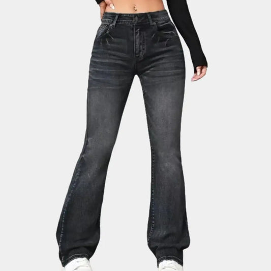 Black jeans worn by a person on a white background