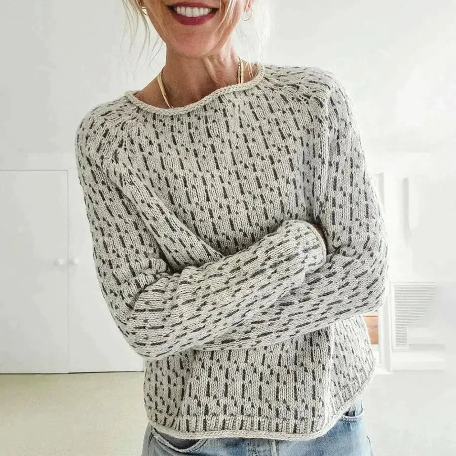 Woman wearing a textured sweater in a minimal indoor setting