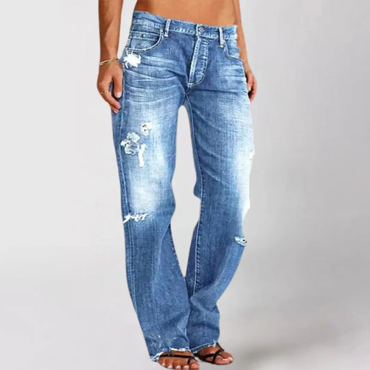 Blue jeans with distressing details on a plain background