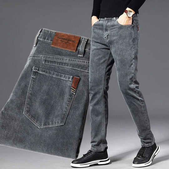 Gray jeans displayed with a person wearing them on a gray background