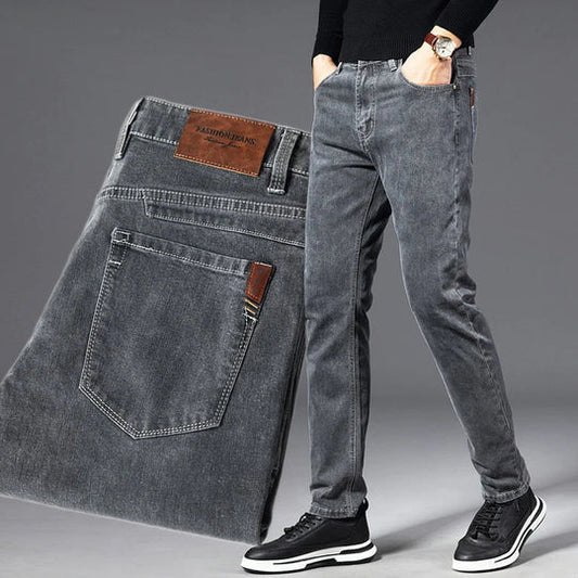 Gray jeans displayed with a person wearing them on a gray background