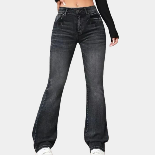 Black jeans worn by a person on a white background
