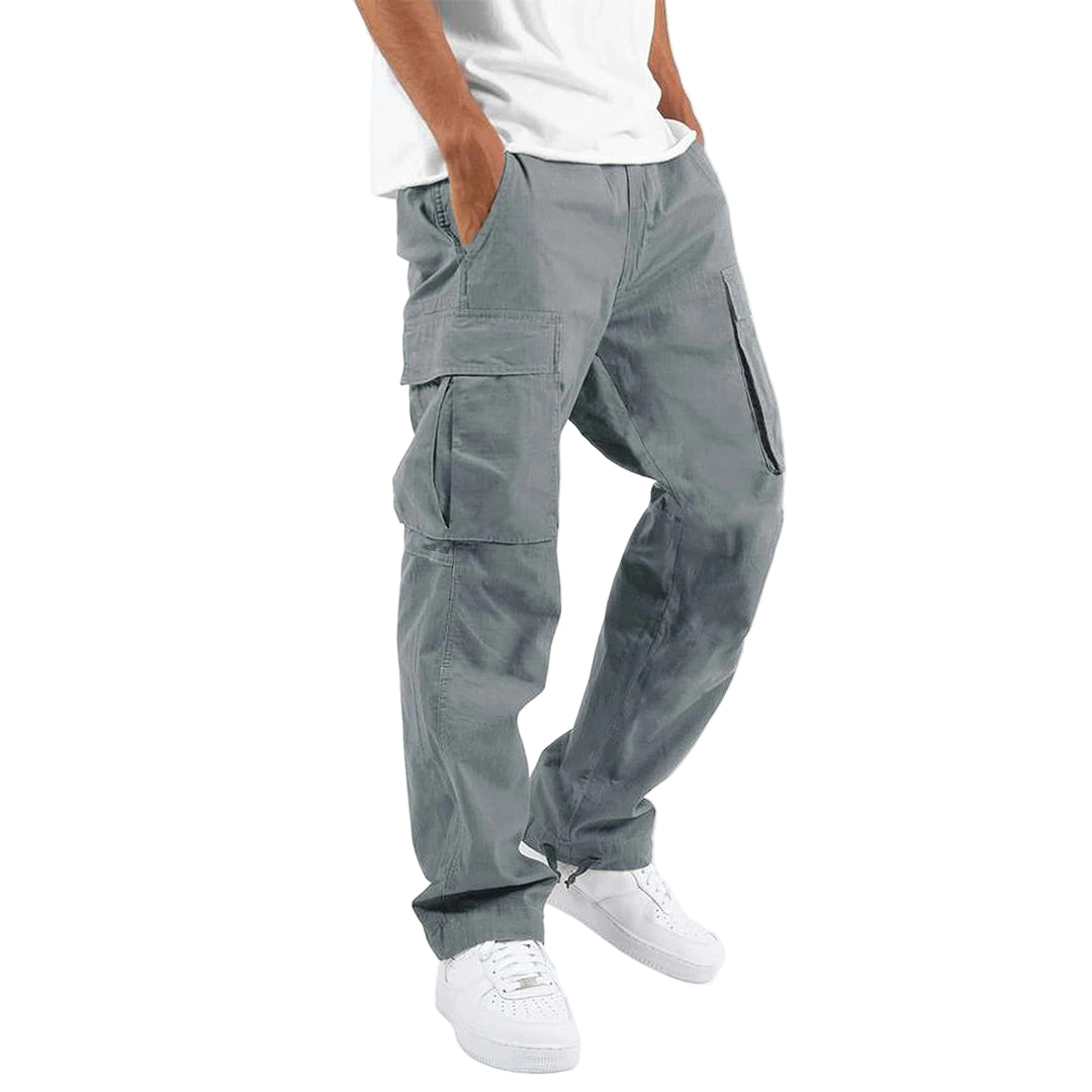 Person wearing gray cargo pants on a white background