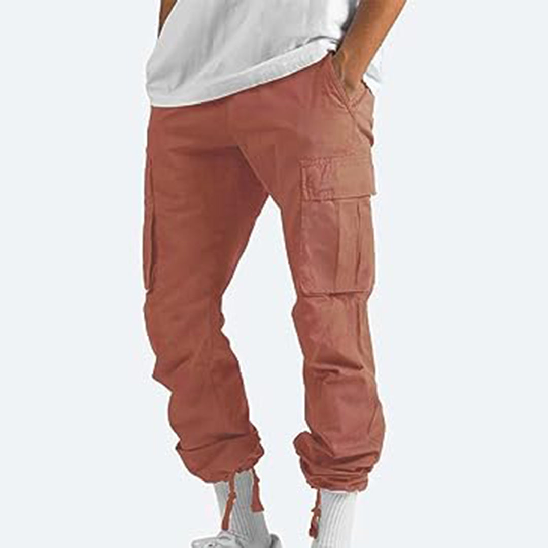 Brown cargo pants worn by a person on a white background