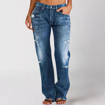 Blue jeans with slight distressing on a plain background