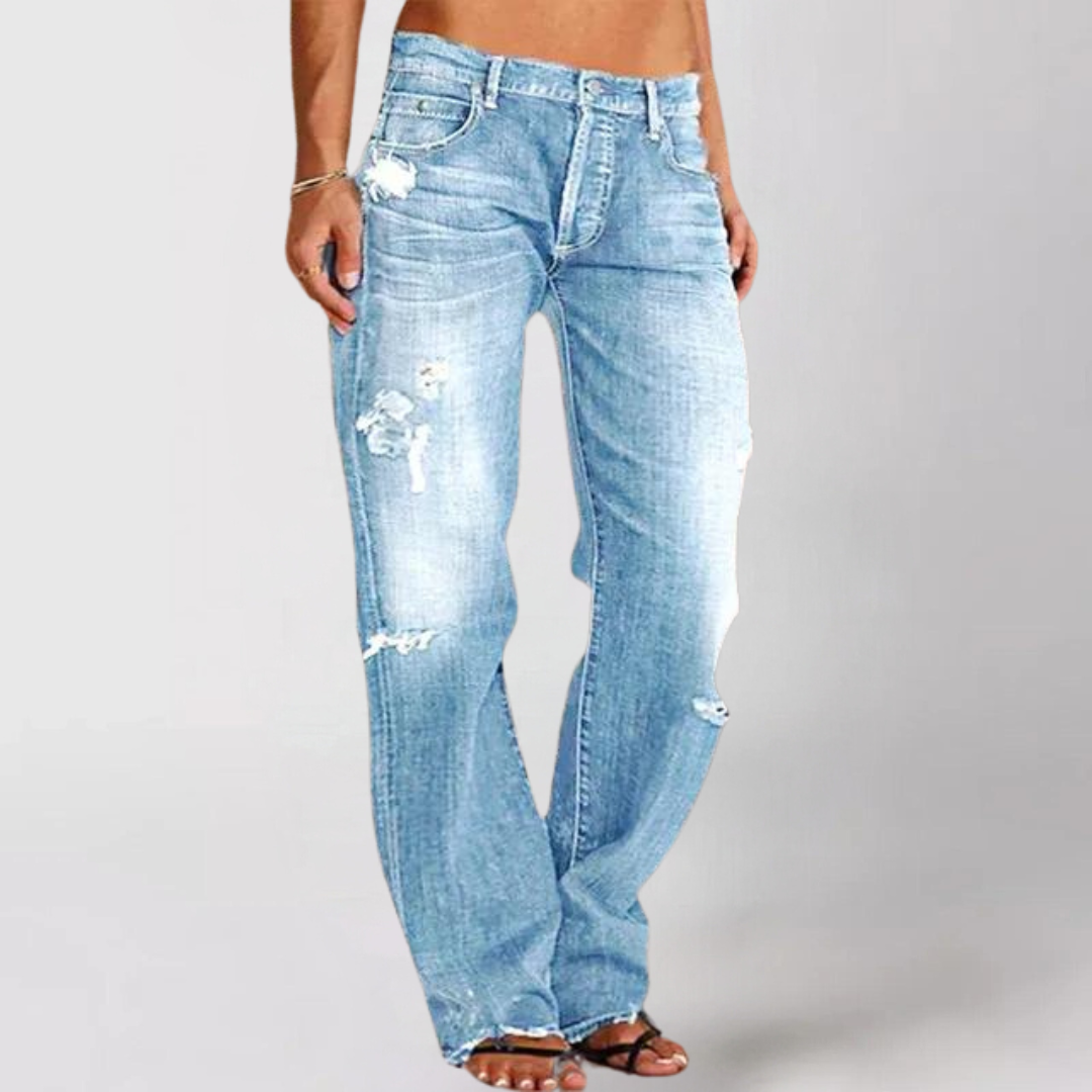 Light blue distressed jeans worn by a person on a plain background