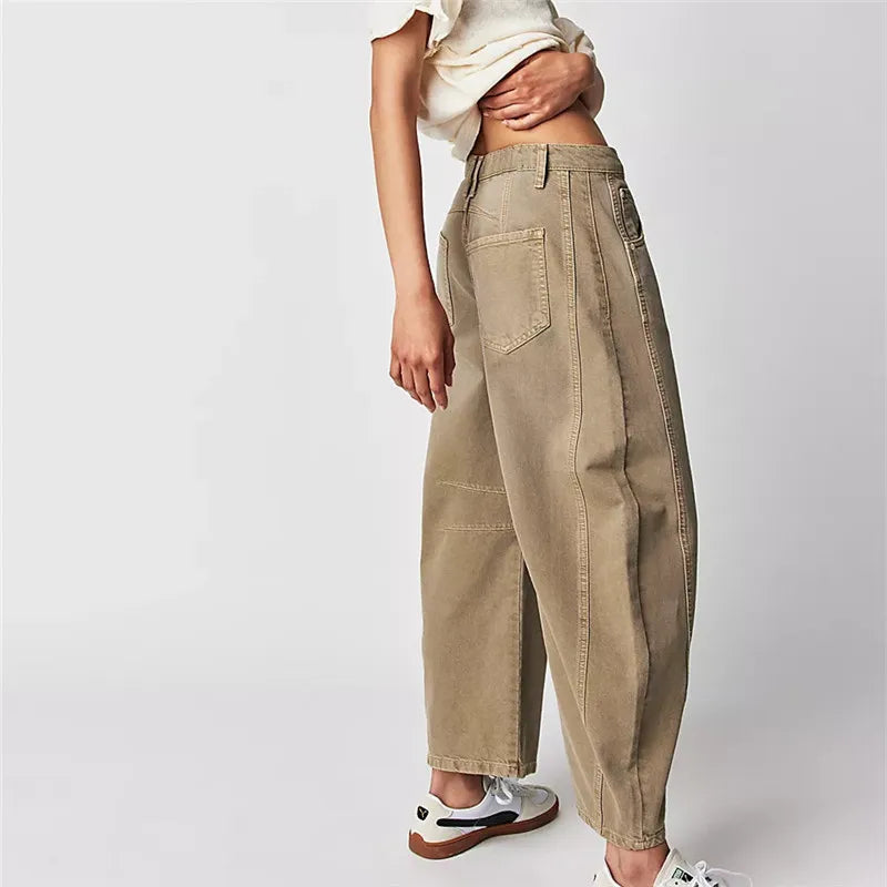 Beige pants worn by a person on a white background