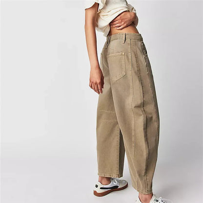 Beige pants worn by a person on a white background