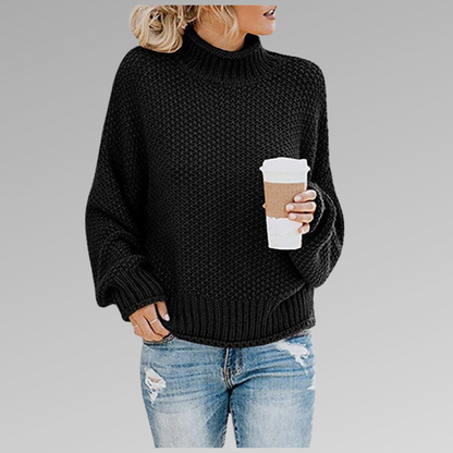 Woman in black knit sweater with coffee mug, casual fashion, autumn outfit.