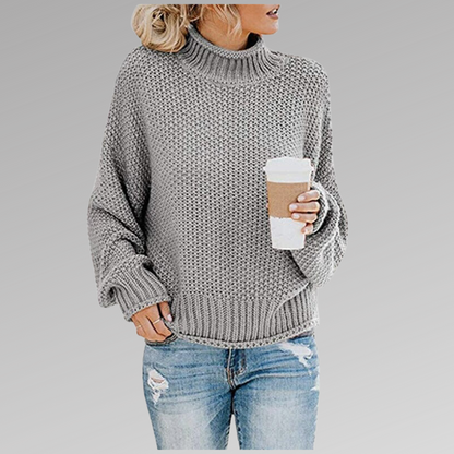 Woman in grey knit sweater with coffee mug, casual fashion, autumn outfit.