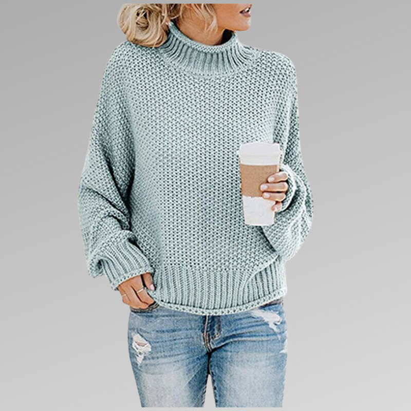 Woman in light blue knit sweater with coffee mug, casual fashion, autumn outfit.