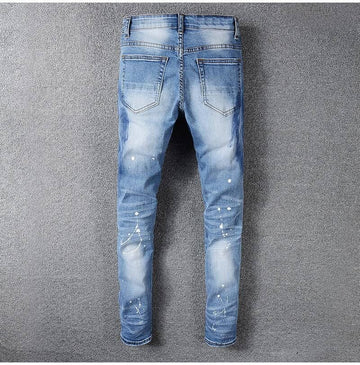 Blue distressed jeans on a gray background