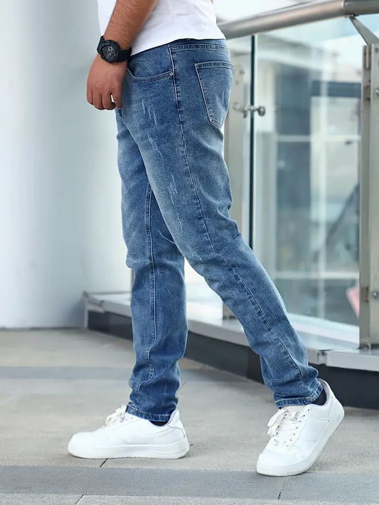 Person wearing blue jeans and white sneakers in an urban setting