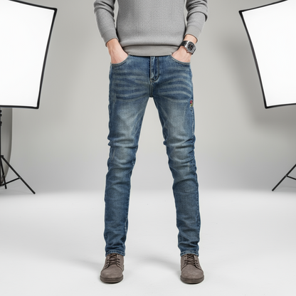 Person wearing blue jeans against a gray background