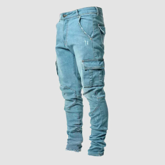 Light blue jeans with multiple pockets on a light gray background