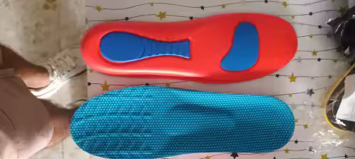 Red and blue shoe insoles on a patterned surface