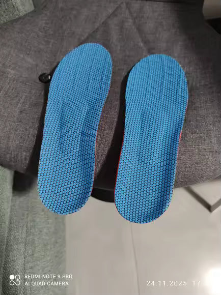 Two blue shoe inserts on a gray surface